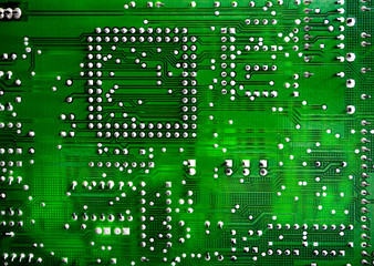 Close-up of printed electronic circuit board with processor and many integrated electrical...