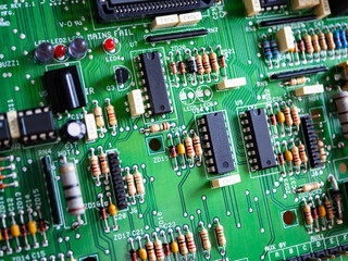 Close-up of printed electronic circuit board with processor and many integrated electrical...