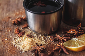 Freshly homemade mulled wine in a bowl with fragrant species, citrus fruits, lemon on a wooden...