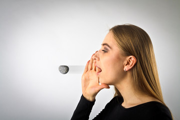 Young woman in black is screaming at something. Screaming. Word like a stone.