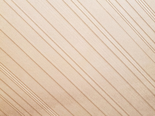 Fototapeta premium Close-up of the surface of the beige stucco wall. Porous cement or gypsum plaster. The image is in the form of diagonal lines. Texture of wall background. The concept of interior design.
