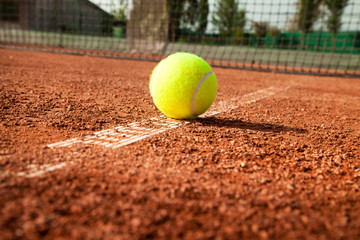 Tennis ball with racket on court 