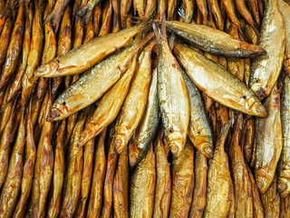 Beautiful brown-golden smoked fish. Close-up of smoked fish. Various lake or sea fish. Tasty and healthy food. For sale in the market.