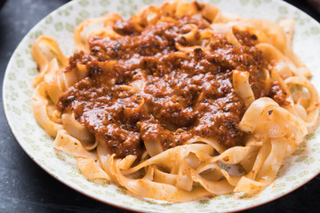 Italian ragu bolognese with flat fettuccine pasta