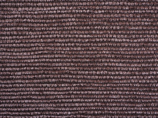 Close-up of the brown carpet textile texture, background and wallpaper. The texture of brown fabric textile upholstery of furniture. High-quality macro photography.