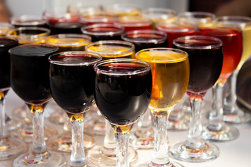 rows of glasses of different port wines