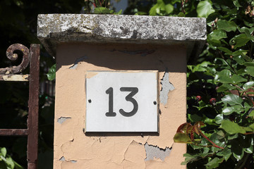 Number 13 thirteen street house address building gate plate detail close up