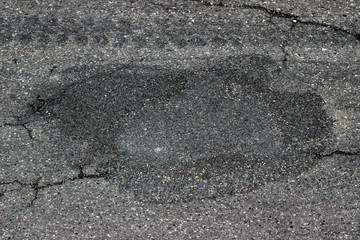 New and old asphalt surface circular patch road street