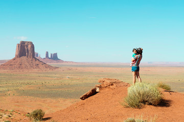 USA, Utah, Monument Valley, Mother traveling with baby girl, mother carrying girl, standing on viewpoint