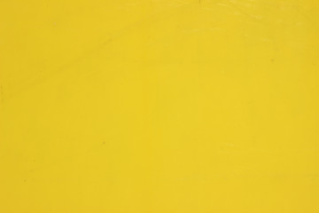 Smooth yellow plastic surface with lines markings traces fragment