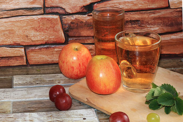 Grape and apple juice, fruit on a wooden background. Cool drinks, a mix of different varieties of...
