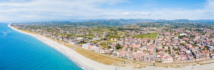 Fototapeta na wymiar Città costiera di Siderno in Calabria, vista aerea. Meta turistica in Estate e della Locride. Lungomare rifatto, strade e case in campagna.