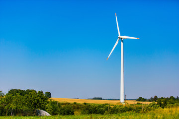 Fototapeta na wymiar Alternative energy resource. Wind turbine situated on outskirts