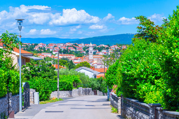 City Krk on island Krk in the Adriatic Sea in Croatia. Wonderful romantic summertime cityscape in emerald green coastline slopes.