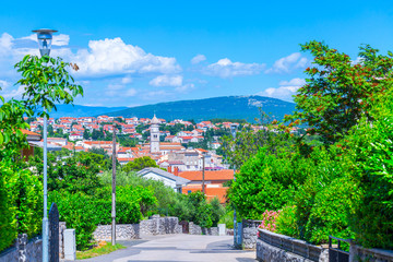 Fototapeta na wymiar City Krk on island Krk in the Adriatic Sea in Croatia. Wonderful romantic summertime cityscape in emerald green coastline slopes.