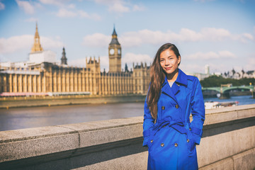London woman european city traveler in blue trench coat outerwear at famous UK travel destination,...