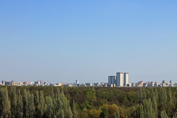 Fototapeta na wymiar Panoramic view from above on Izmailovsky Park in Moscow Russia with gentle green trees, architecture and the horizon against the clear sky