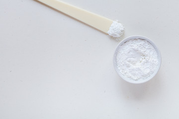 White alginate mask on white background, top view. Beauty routine products.