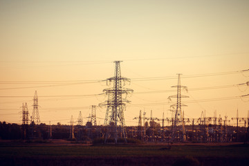 Electricity poles in the field. Industry electricity. Light in the house. Metal structures in the field.