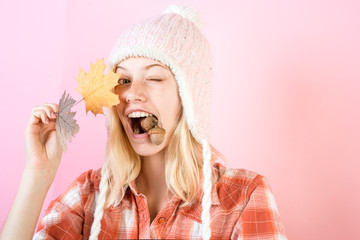 Surprise woman playing with leaves and looking at camera. Girl in autumn are getting ready for autumn sale. Girl in autumn playing with leaves on autumn leaves background.