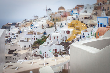 Tilt shift effect of the colorful village of Oia on a cloudy day