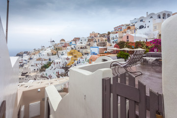 View of colorful houses of Oia on a rare rainy day