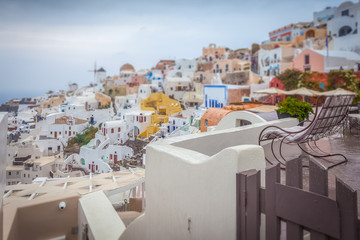 Tilt shift effect of the colorful village of Oia on a cloudy day