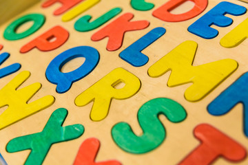 Alphabet with wooden letters in a children's classroom.