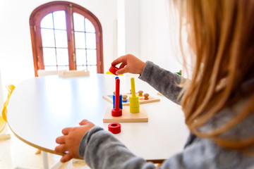 Girl developing her manual dexterity with a sensory material of colors.