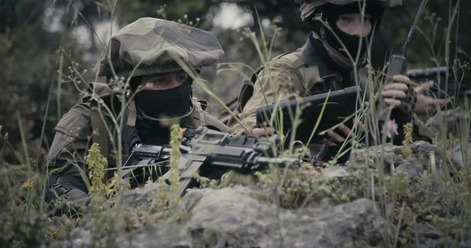 Israeli soldiers in a surveillance and reconnaissance mission using binoculars