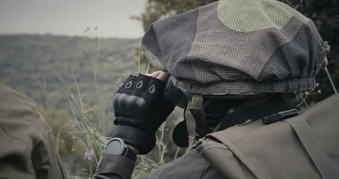 Israeli soldiers in a surveillance and reconnaissance mission using binoculars