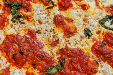 Obraz na płótnie Canvas A real tasty cheese pizza from a restaurant as background.