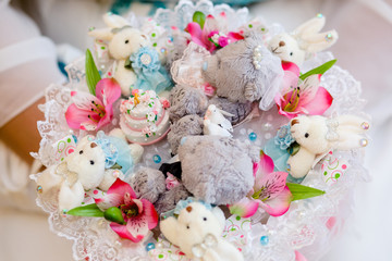 Multicolored bouquet with pink flowers and soft toys