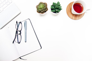 Workspace with laptop, notebook, sketchbook, succulent, cup of tea on white background. Flat lay, top view office table desk. Freelancer working place. copyspace