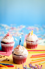 Birthday cupcake with candles and colorful background