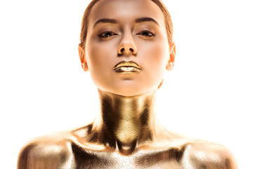 portrait of nude young woman painted in golden looking at camera isolated on white