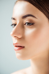Obraz premium close up of young woman with shiny lips and golden eye shadow isolated on grey