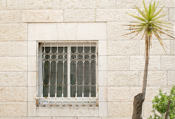 old window on wall of stone in Jerusalem Israel 