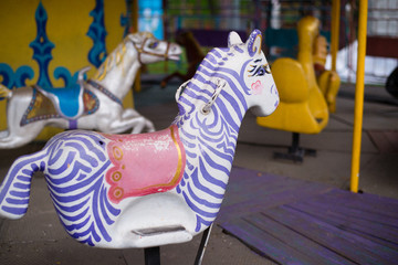 Fototapeta na wymiar horses on an old retro carousel