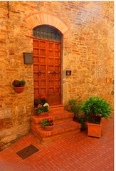 Fototapeta na wymiar A wooden door in a Tuscan hill town in northern Italy