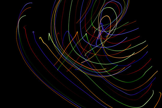 Abstract colorful lines on black background. Light painting photography with irregular patterns for overlay. Resource for designers.
