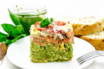 Casserole of salmon and rice in plate on board