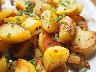 delicious crispy fried potatoes garnished with chive