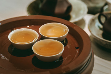 The Chaozhou Kong Fu Tea in tea cup on the teaboard. Traditional chinese catering culture.