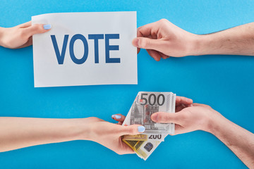 partial view of woman giving bribe for vote to man on blue background