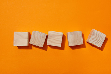 top view of wooden blocks on orange surface