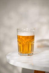 A glass of beer on the table.