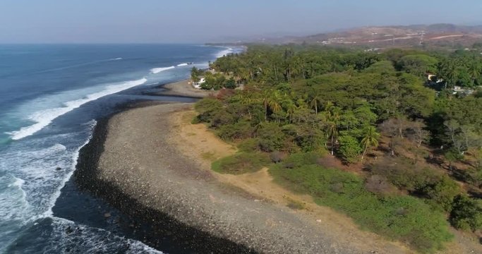 Lush tropical summer beach with palm trees. Aerial drone view of famous coastline great for travel and leisure. Airflow Creations tourism landscape.