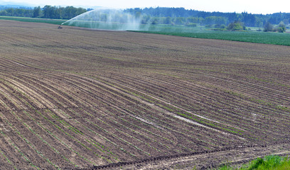 Tilled soil on farm with rural landscape, western United States