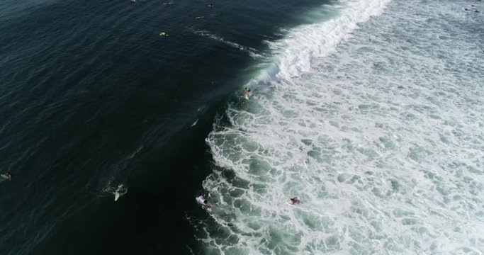 SLOW MOTION Surfer riding wave aerial view on point break in Central America. El Salvador's famous Punta Roca long wave. Drone video of action sports with Airflow Creations.